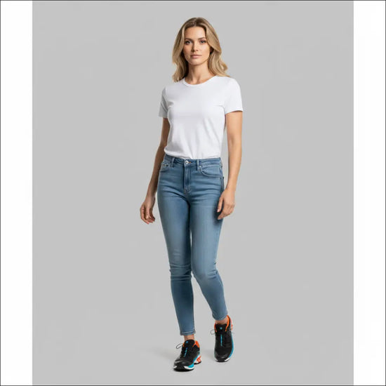 Woman wearing blue jeans and a white t-shirt with Salomon XT-Wings sneakers showcasing a stylish casual look.