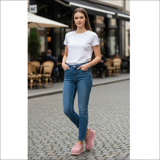 UGG Tazz in Pink Dawn worn by a model in casual outfit, showcasing pink suede slippers in urban setting.